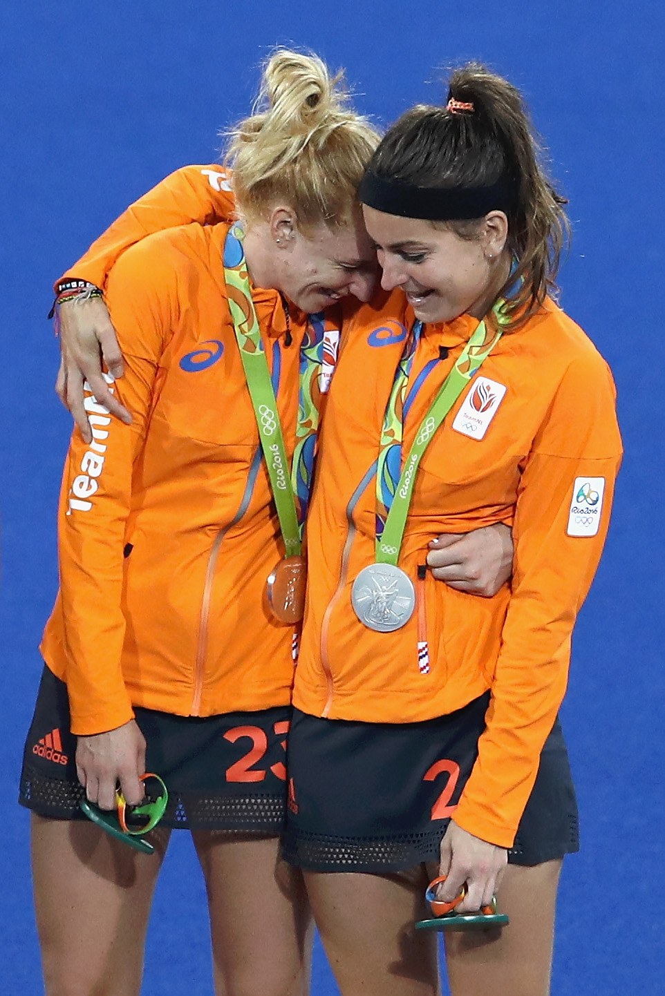 RIO DE JANEIRO, BRAZIL - AUGUST 19: Margot van Geffen #23 (L) and Eva de Goede #24 of Netherlands react on the podium after winning silver medals in the Women's Hockey Final match against Great Britain on Day 14 of the Rio 2016 Olympic Games at the Olympic Hockey Centre on August 19, 2016 in Rio de Janeiro, Brazil. (Photo by Mark Kolbe/Getty Images)
